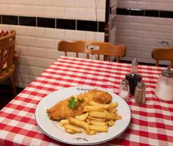 Plate with fish and chips on a table 