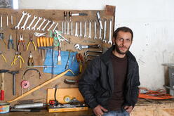 Baraa, a Lebanese mechanic standing against his tools