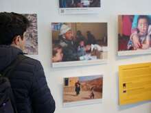 Attendee of the European Humanitarian Forum visiting the IRC's photo exhibition