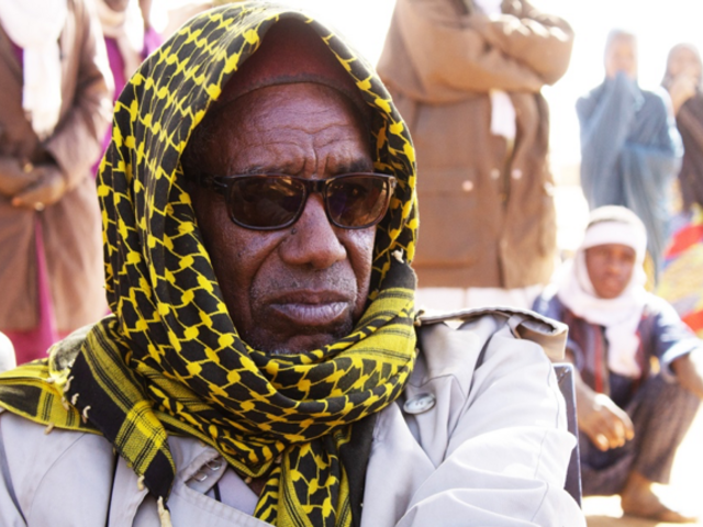 Man with headscarf and sunglasses