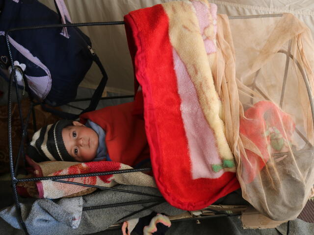 Jumana’s four-month-old baby, Sameer sleeping in a crib which is part of the IRC’s newborn kits.