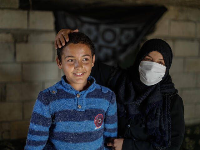 Tareq, 10-year-old Syrian with his mother
