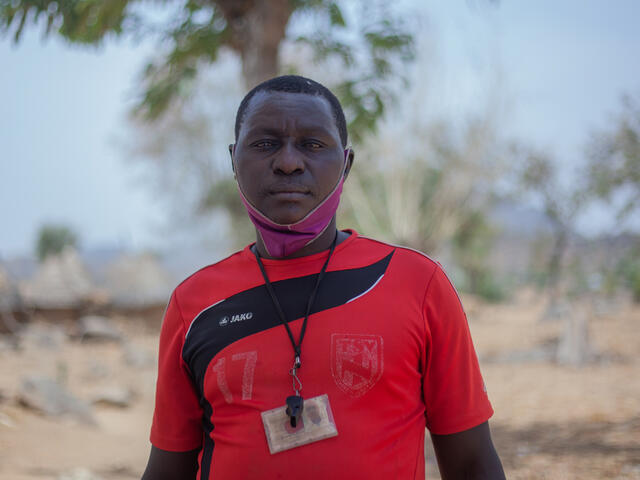 Portrait of Komonda standing outside in his village