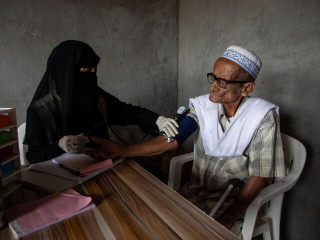 A man undergoes medical checks with IRC staff