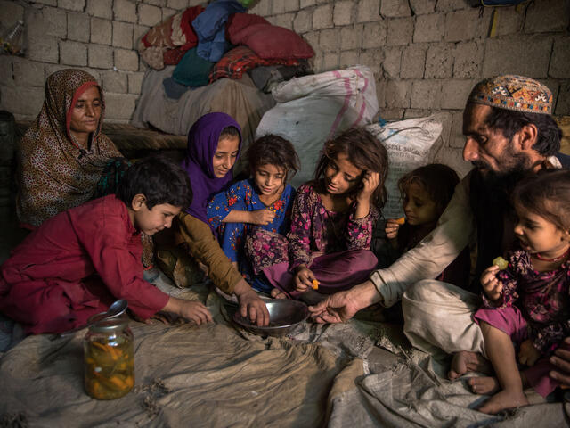 An Afghan family sitting in their tent