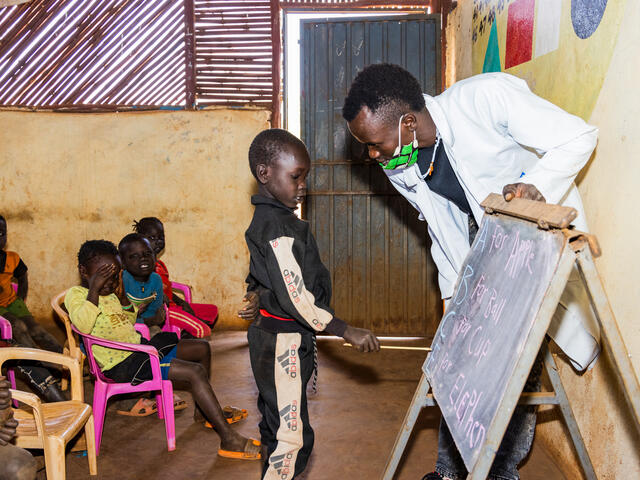A young boy learning in a classroom