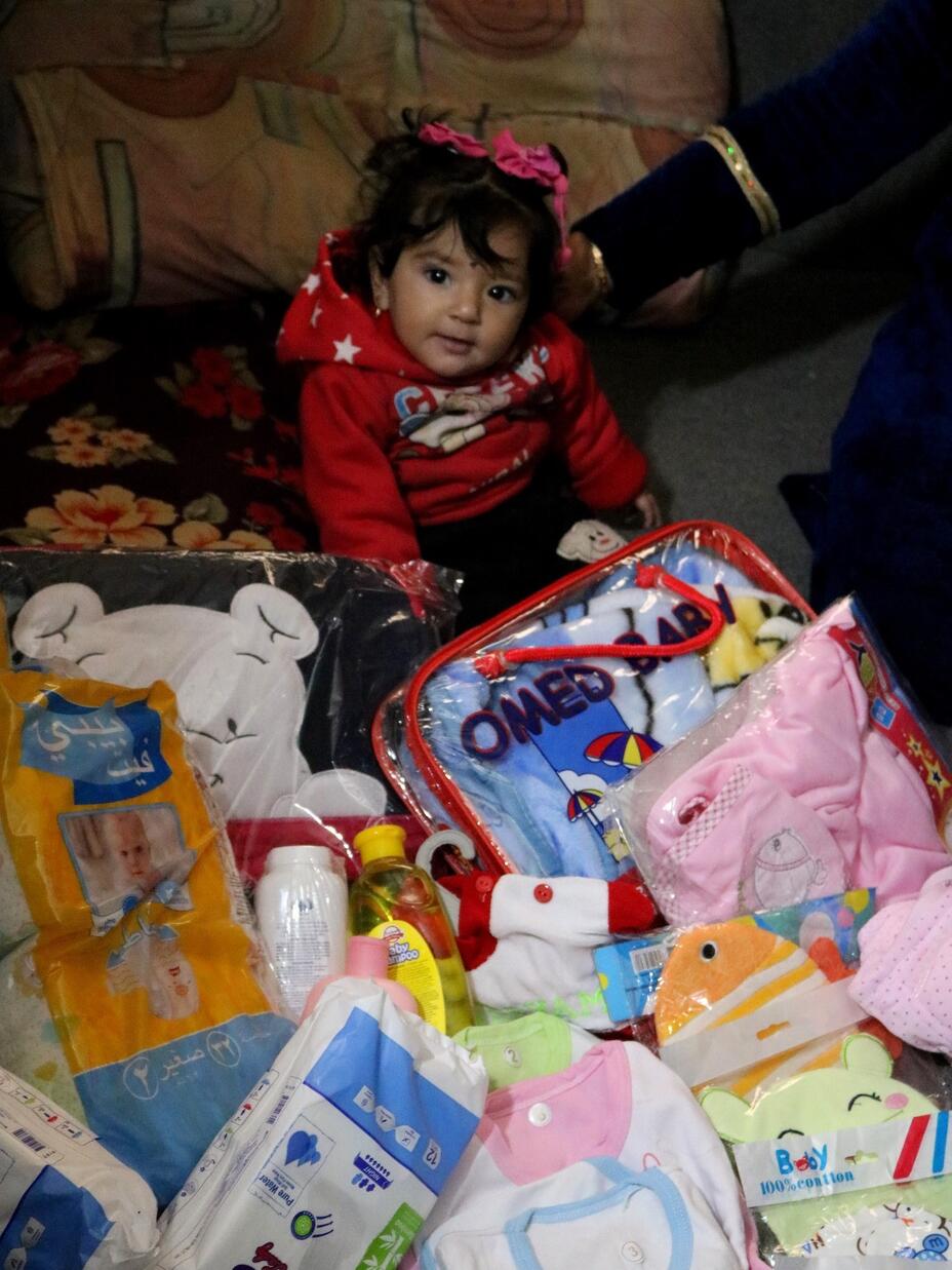 Baby Zainab plays amongst the items which are part of the newborn kit, provided by the IRC to Syrian mothers.