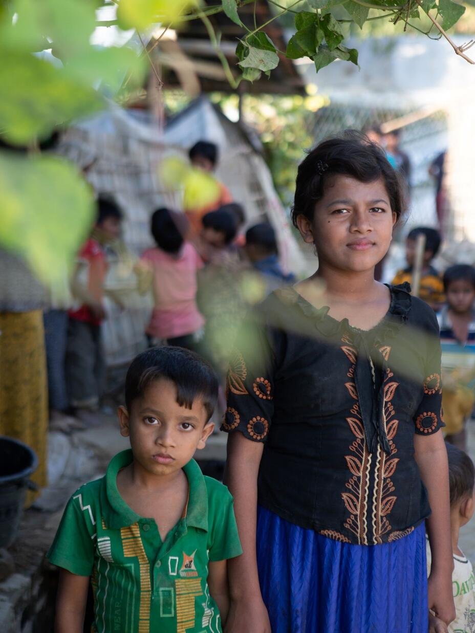 Rubijan stands with her younger brother in Teknaf camp in Bangladesh