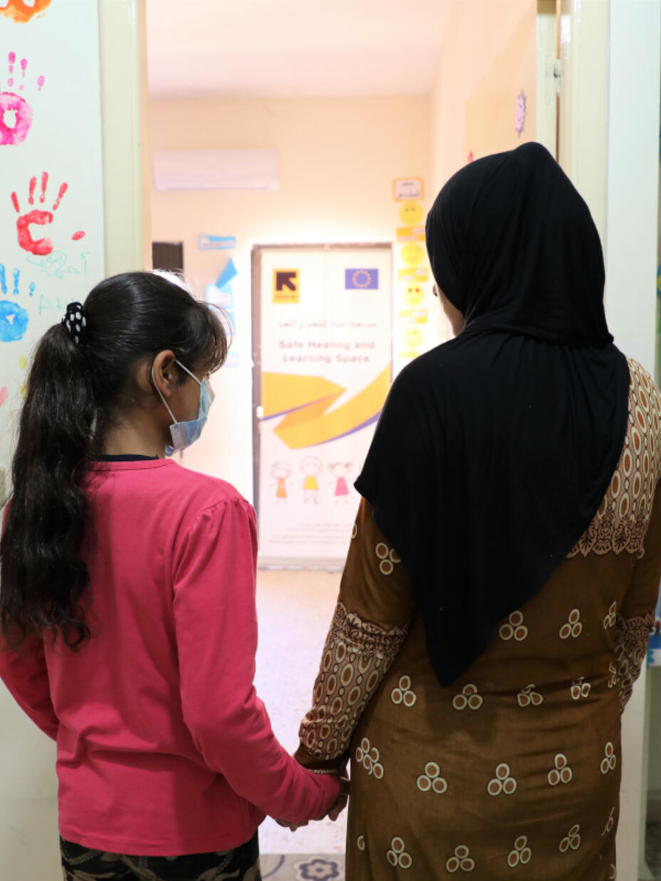 Gharam and her mother standing in the IRC Centre