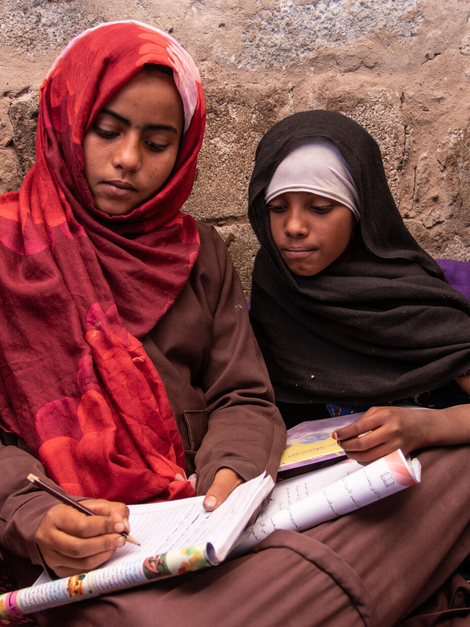 Aisha and Na'aem doing schoolwork together