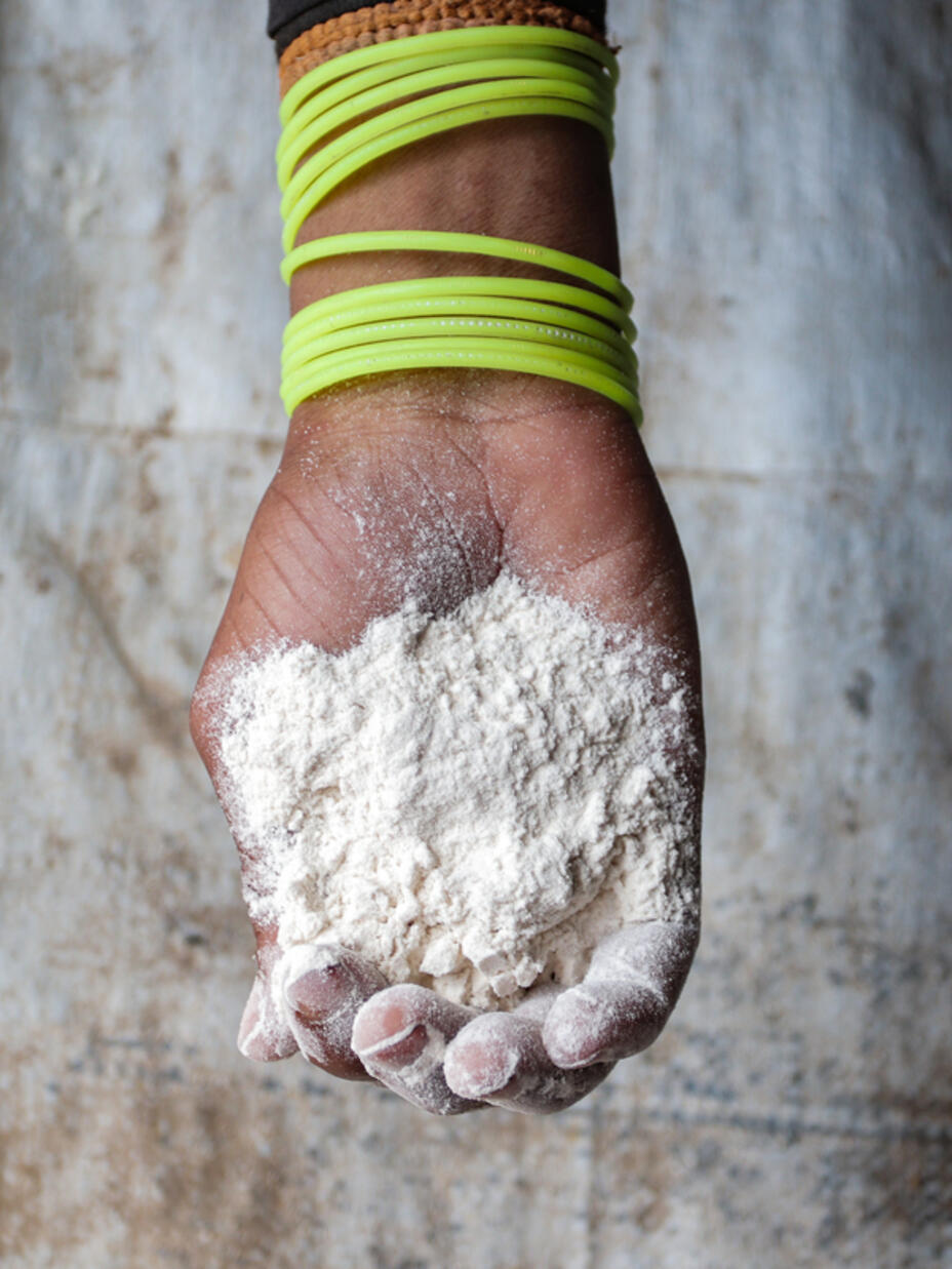 Close up shot of a hand holding flour