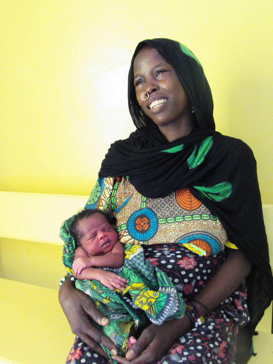 Kaltouma holds her baby in IRC health centre