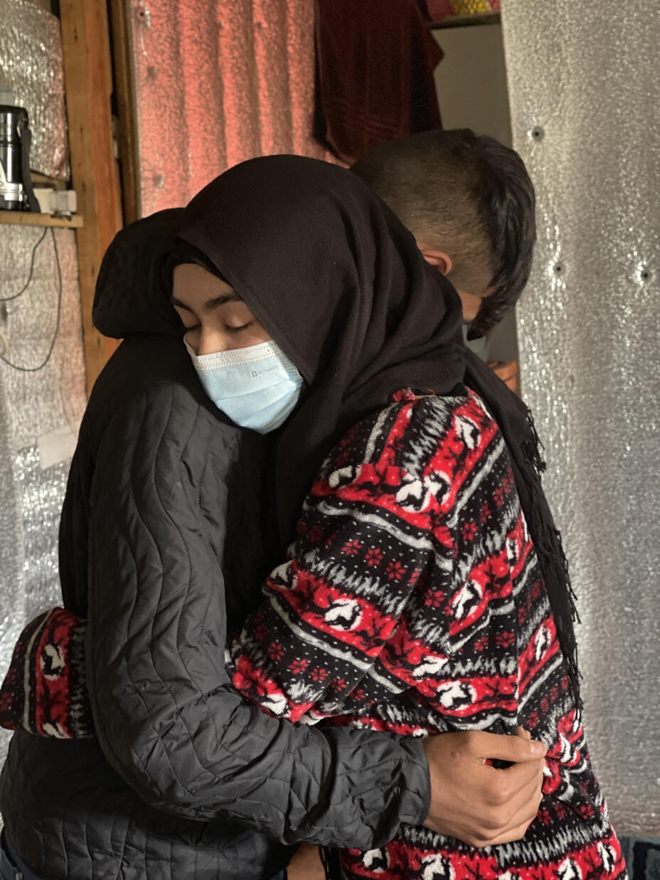Portrait shot of Lina hugging her brother Ahmad