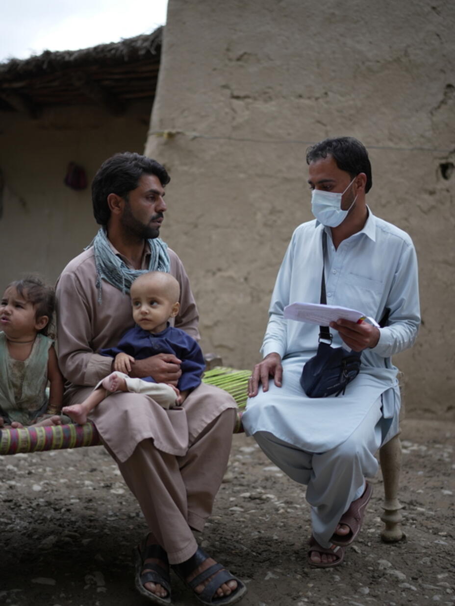 An IRC staff member visits Shakeel, father of twins, at his home in order to check up on the children's health