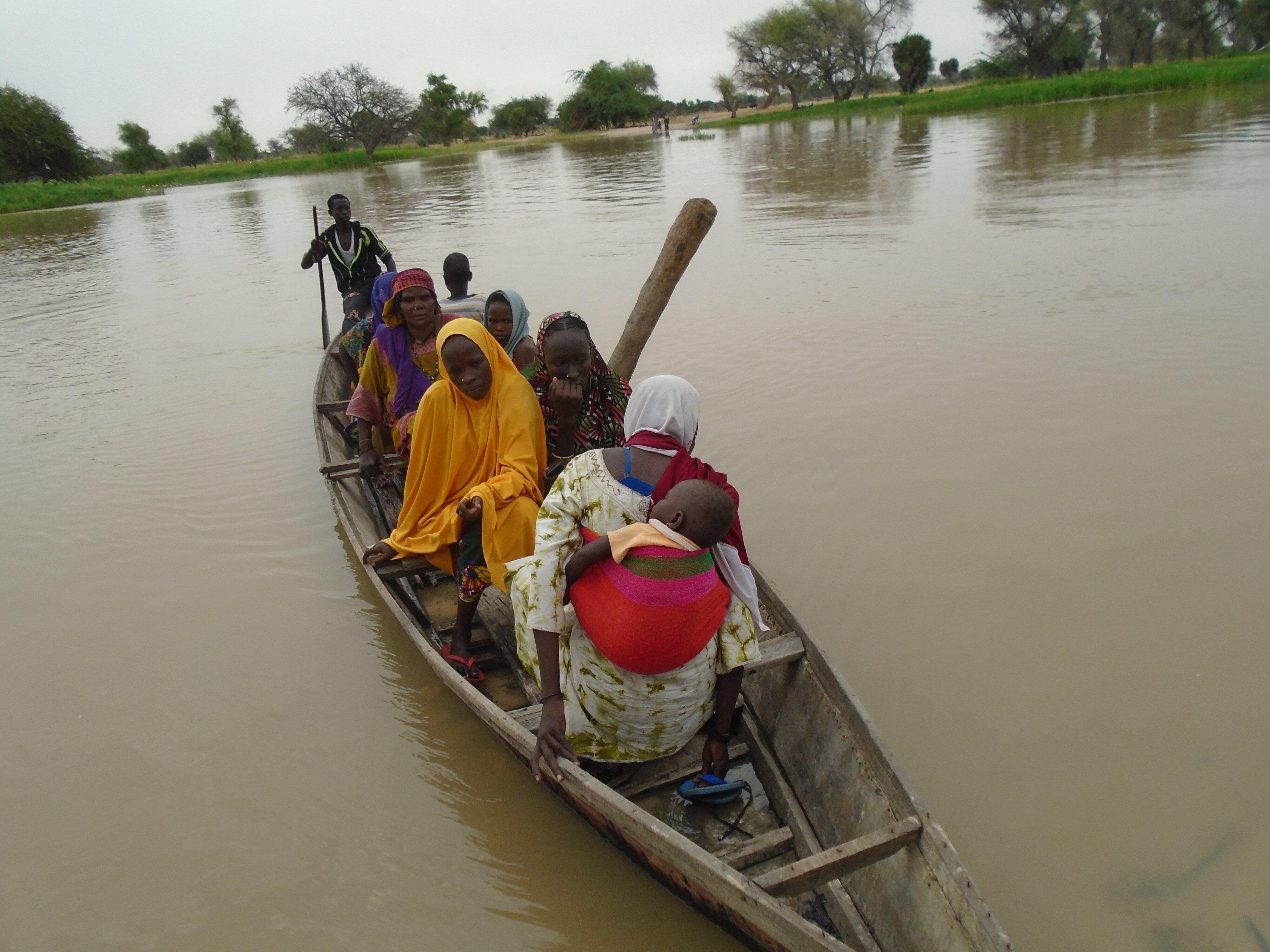 Some People in small boat in muddy water