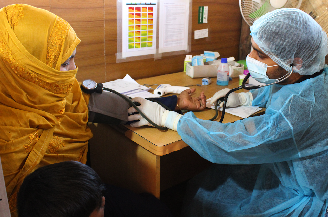 A woman getting her temperature measured in the IRC clinic in Bangladesh.
