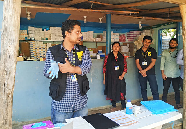 In Cox's Bazar refugee camp in Bangladesh, Dr. Mahmud demonstrates the proper way to put on gloves for health workers and health volunteers. 