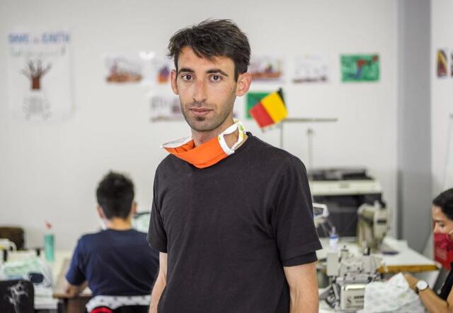 Ammar standing in a workshop making masks during the pandemic
