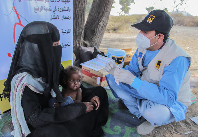 Asrar and Tahani receiving malnutrition treatment from IRC healthworker