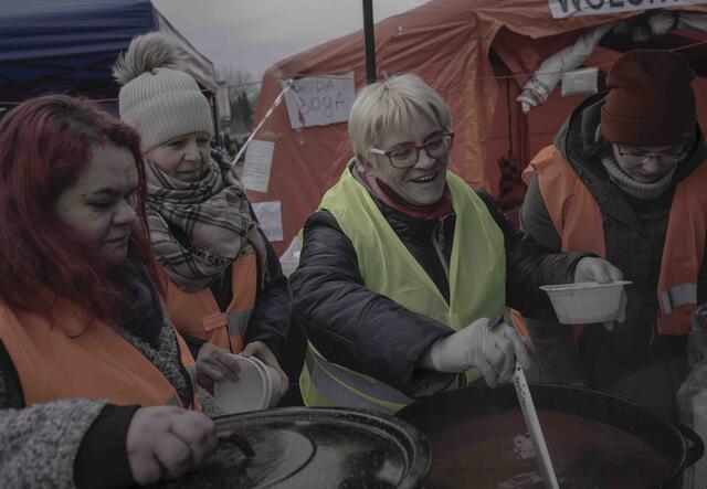 Volunteers distribute meals to Ukrainian refuges at the Tesco reception center, Przemysl, Poland