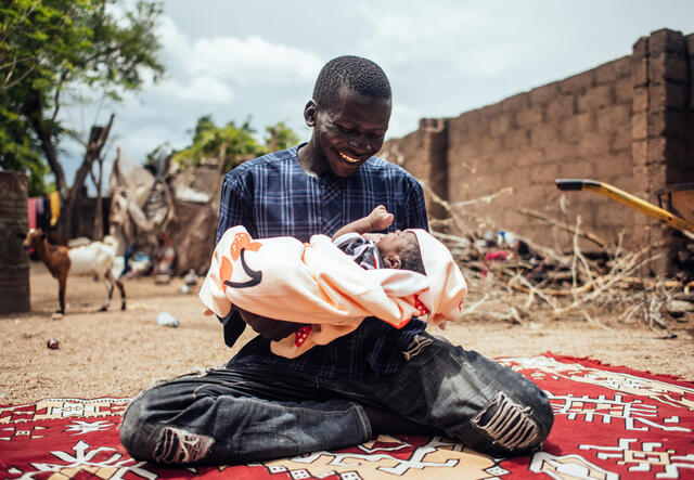 Portrait of Ibrahim Ali, 24 and his baby, Bello Ibrahim, 7 days old, few hours after his child’s naming ceremony at his home in Gwoza, Borno, Nigeria