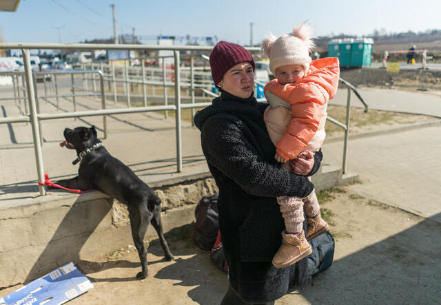 A Ukrainian mother with her daughter and dog.