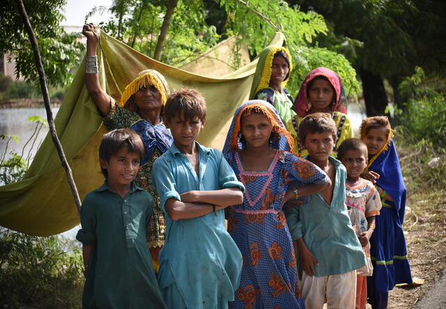 A family is seen pitching a tent as a temporary shelter in Mirpur Khas district of Sindh, Pakistan
