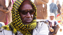 Man with headscarf and sunglasses
