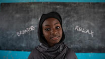 Portrait of Hauwa in front of the chalkboard