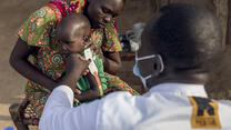 An IRC healthcare provider checks a baby for malnutrition in South Sudan