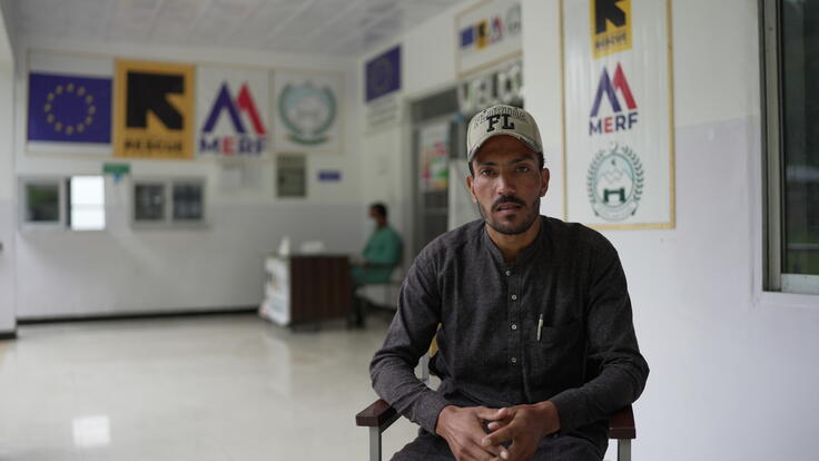 Khalid, a patient seeking mental support at the IRC facility, sits in a chair at the hospital facing the camera